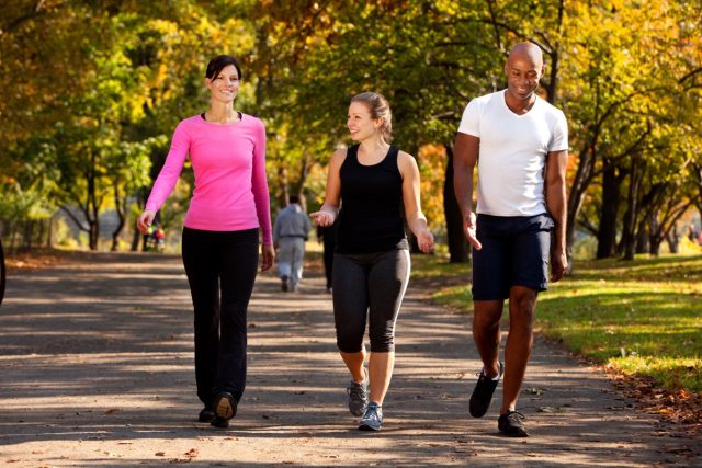 three-friends-walking-park.jpg